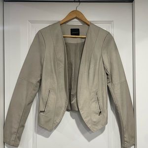 Beige leather jacket with stretchy patches and zippers